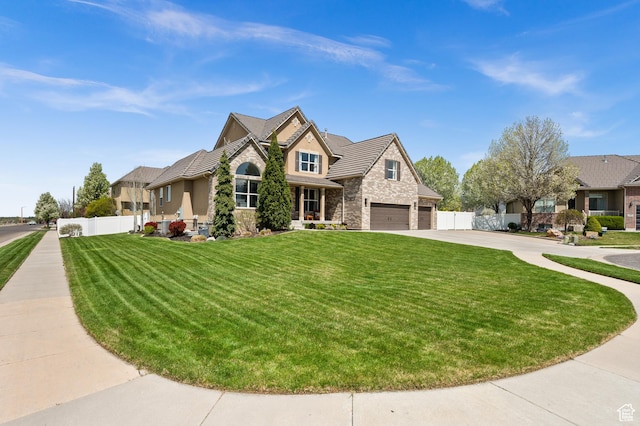 322 Flour Mill Dr, Kaysville, UT 84037 - craftsman-style house featuring concrete driveway, fence, stone siding, and a front yard