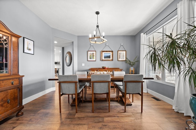 322 Flour Mill Dr, Kaysville, UT 84037 - dining area featuring baseboards, visible vents, an inviting chandelier, and dark wood finished floors