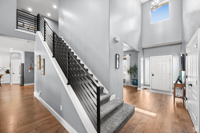 322 Flour Mill Dr, Kaysville, UT 84037 - entryway with stairway, wood-type flooring, and a towering ceiling