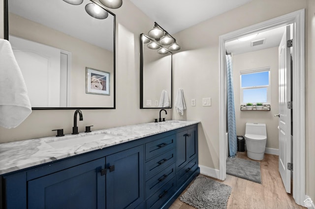 322 Flour Mill Dr, Kaysville, UT 84037 - bathroom with toilet, wood finished floors, a sink, and visible vents
