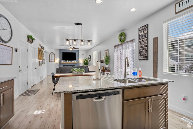 13137 S Acklins Dr, Herriman, UT 84096 - kitchen with visible vents, a ceiling fan, stainless steel dishwasher, a sink, and light wood-type flooring