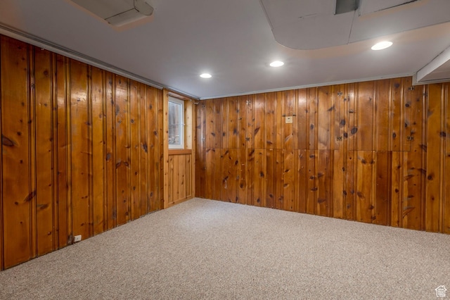basement featuring recessed lighting, wooden walls, and carpet flooring