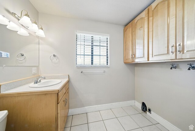 107 Country Club Dr, Stansbury Park, UT 84074 - interior space featuring laundry area, a sink, baseboards, and light tile patterned flooring