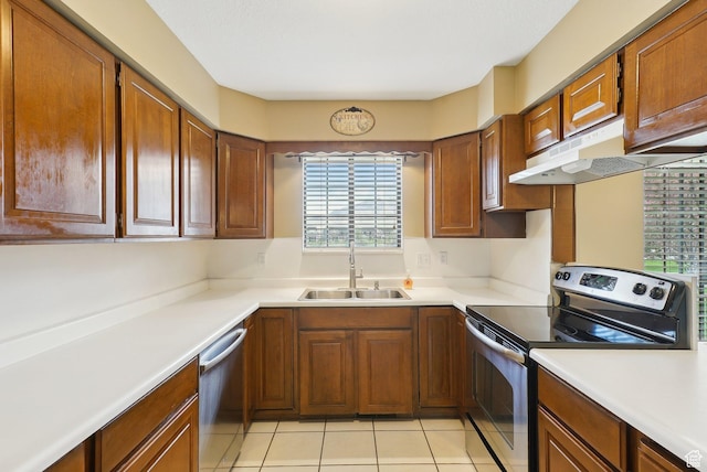 107 Country Club Dr, Stansbury Park, UT 84074 - kitchen featuring appliances with stainless steel finishes, a sink, light tile patterned floors, light countertops, and under cabinet range hood