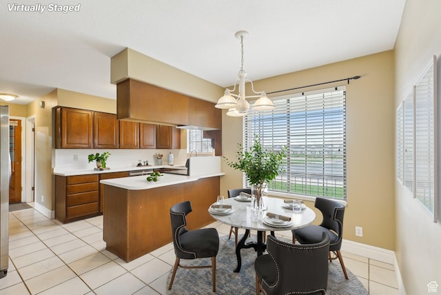 107 Country Club Dr, Stansbury Park, UT 84074 - dining room with light tile patterned flooring, baseboards, and a notable chandelier