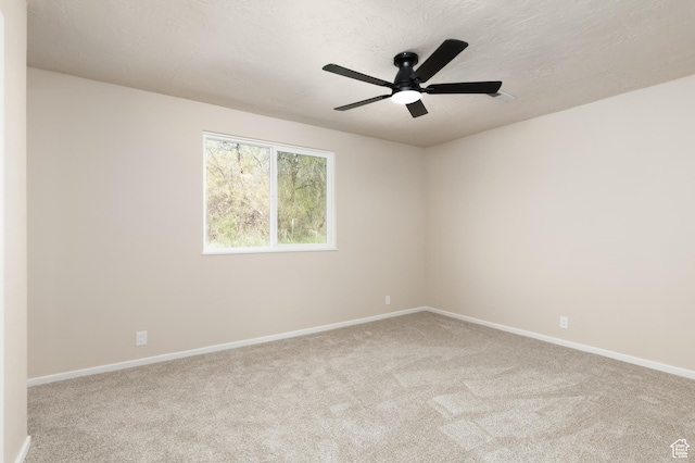 unfurnished room with carpet and baseboards
