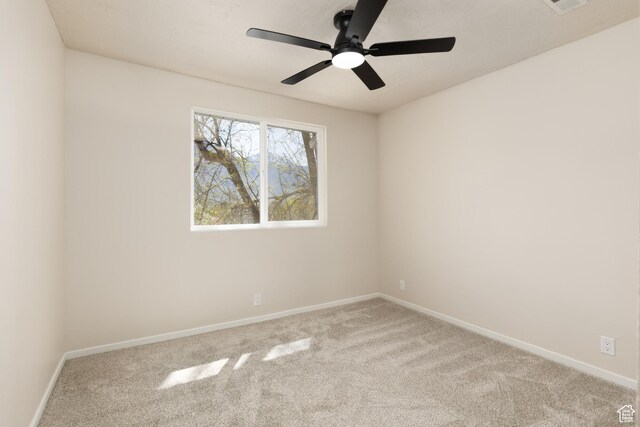empty room with baseboards, a ceiling fan, and carpet flooring