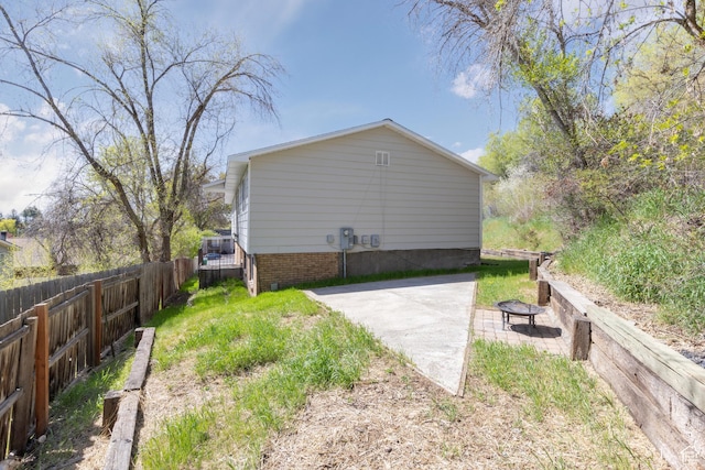 view of yard featuring fence and a patio