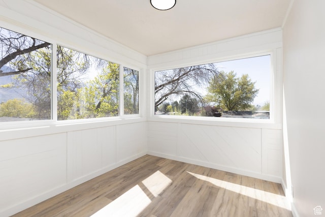 unfurnished sunroom with wood finished floors