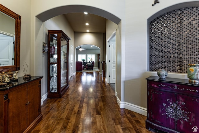 6061 S Bridges Ln, Murray, UT 84121 - hall with baseboards, arched walkways, recessed lighting, and dark wood finished floors