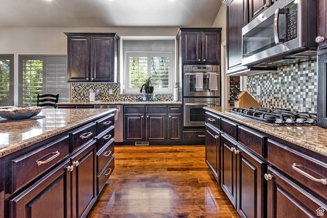 6061 S Bridges Ln, Murray, UT 84121 - kitchen featuring light stone countertops, stainless steel appliances, backsplash, and dark wood-style flooring