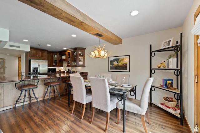dining space featuring visible vents, wood finished floors, an inviting chandelier, and recessed lighting