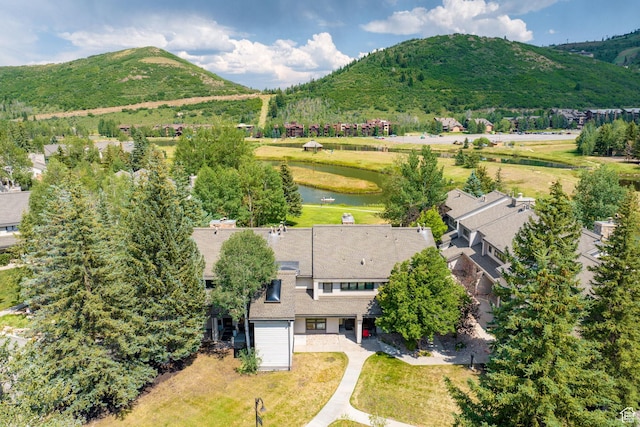 drone / aerial view featuring a water and mountain view