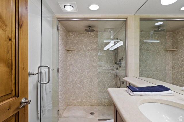 bathroom with vanity and a stall shower