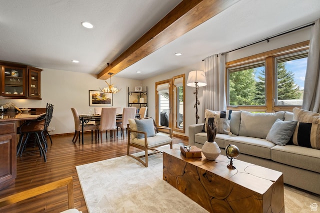 living room with beamed ceiling, plenty of natural light, light wood-style flooring, and baseboards