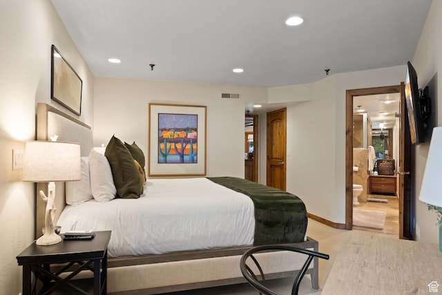 bedroom featuring light wood-type flooring, baseboards, ensuite bath, visible vents, and recessed lighting