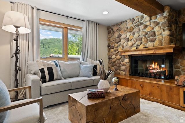 living area featuring beam ceiling, a fireplace, and recessed lighting