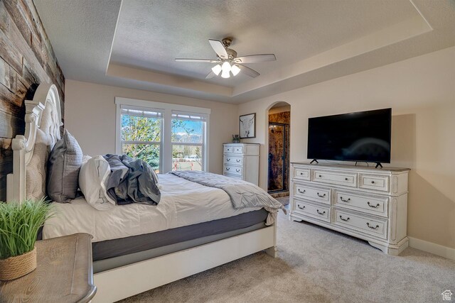 2520 S 260 E, Heber City, UT 84032 - bedroom featuring a ceiling fan, a textured ceiling, arched walkways, a raised ceiling, and light colored carpet