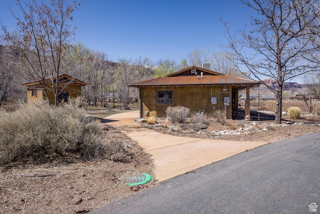 674 E Dragon Fly Trl, Moab, UT 84532 - view of side of property featuring a chimney and metal roof