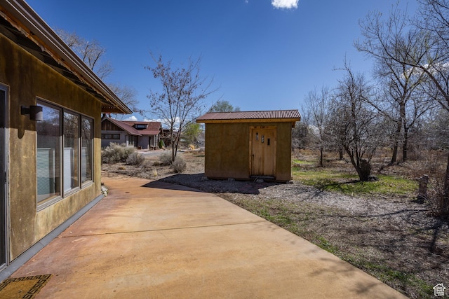 674 E Dragon Fly Trl, Moab, UT 84532 - view of patio featuring an outbuilding and a storage unit