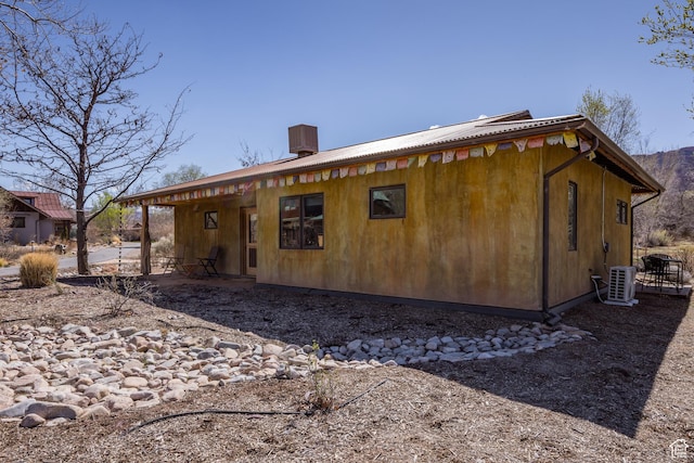 674 E Dragon Fly Trl, Moab, UT 84532 - back of house with central AC unit and a patio area