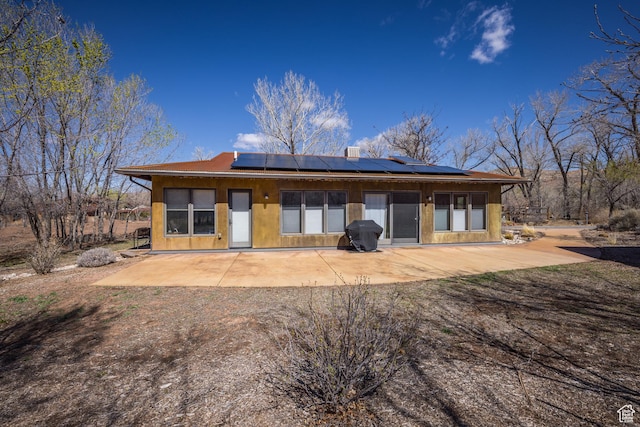 674 E Dragon Fly Trl, Moab, UT 84532 - rear view of property featuring a patio area and solar panels