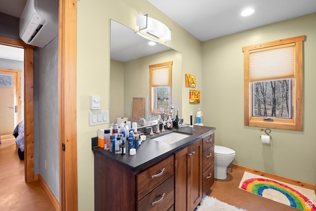 674 E Dragon Fly Trl, Moab, UT 84532 - bathroom featuring toilet, baseboards, recessed lighting, a wall mounted air conditioner, and vanity