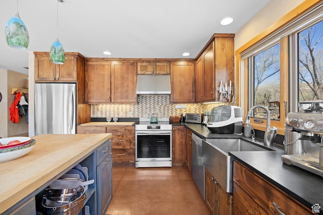674 E Dragon Fly Trl, Moab, UT 84532 - kitchen featuring concrete floors, tasteful backsplash, a sink, appliances with stainless steel finishes, and under cabinet range hood