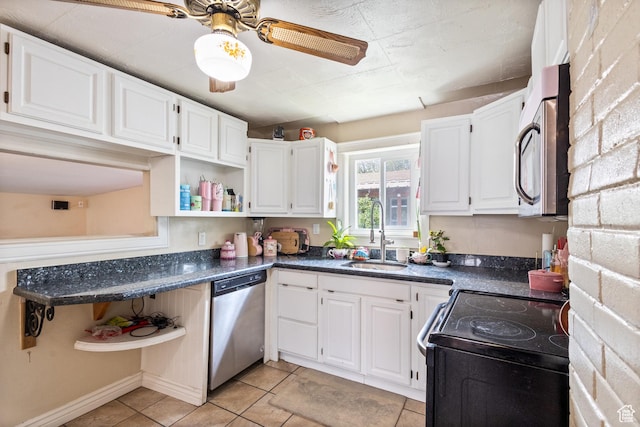 kitchen with stainless steel appliances, a sink, white cabinetry, open shelves, and light tile patterned floors