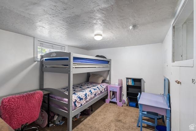 bedroom with a textured ceiling and carpet