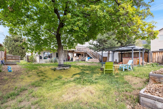 view of yard with a gazebo, a fenced backyard, and a jacuzzi