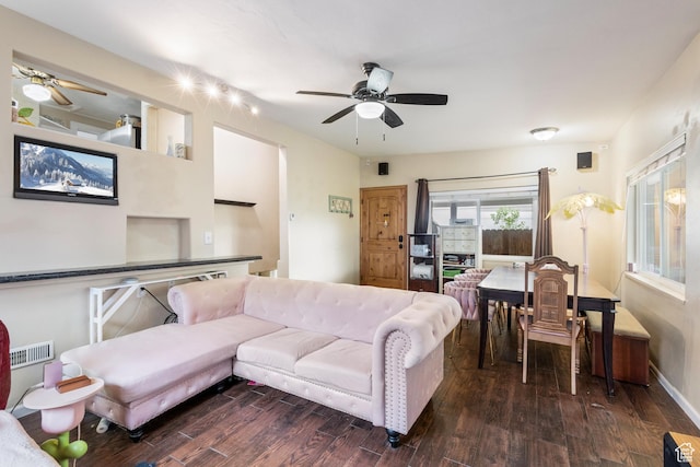 living area featuring visible vents, a ceiling fan, and dark wood-style floors