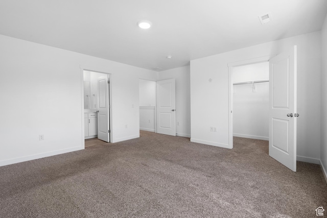 580 Hal St, Stansbury Park, UT 84074 - unfurnished bedroom with a spacious closet, visible vents, a closet, baseboards, and carpet flooring