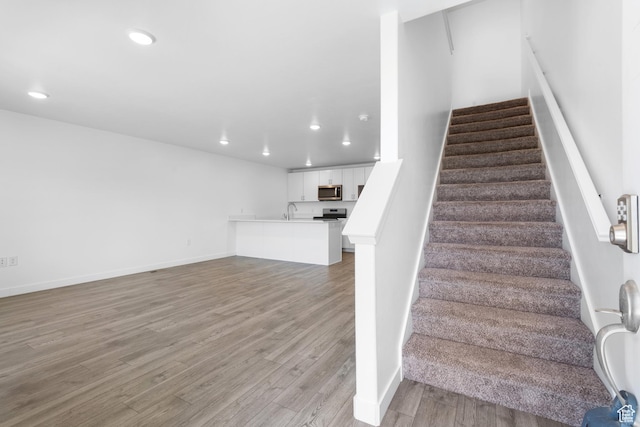 580 Hal St, Stansbury Park, UT 84074 - staircase featuring recessed lighting, wood finished floors, and baseboards