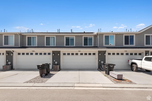 580 Hal St, Stansbury Park, UT 84074 - view of property with stucco siding, driveway, and a garage