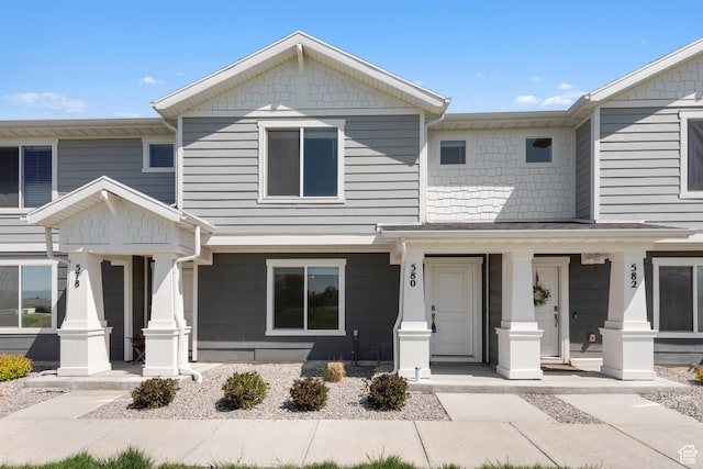 townhome / multi-family property with covered porch