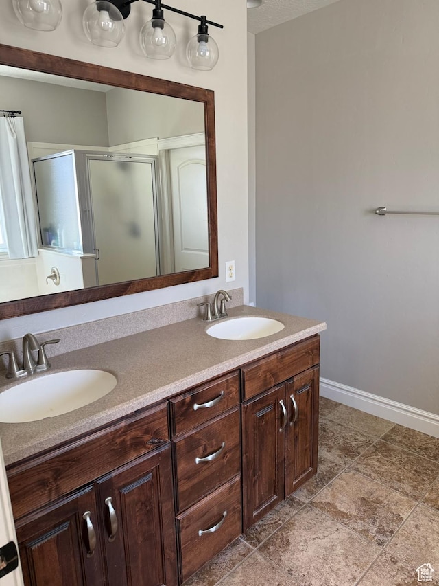 175 N 900 W, Roosevelt, UT 84066 - full bathroom with double vanity, a shower stall, baseboards, and a sink