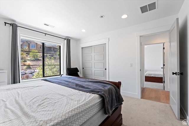 carpeted bedroom with baseboards, recessed lighting, visible vents, and a closet