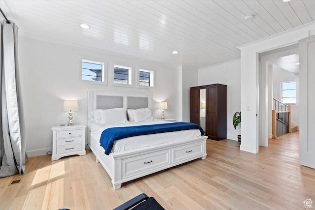bedroom featuring wood ceiling, light wood-style flooring, and multiple windows