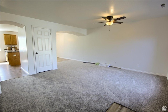 691 N Gramercy Ave, Ogden, UT 84404 - carpeted empty room with arched walkways, visible vents, a ceiling fan, and baseboards