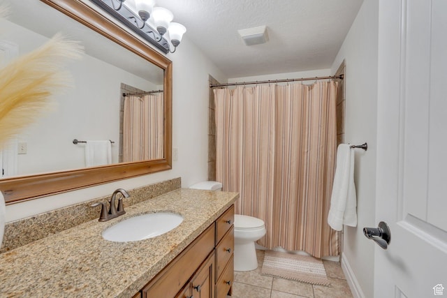 full bathroom featuring a textured ceiling, toilet, curtained shower, tile patterned flooring, and vanity