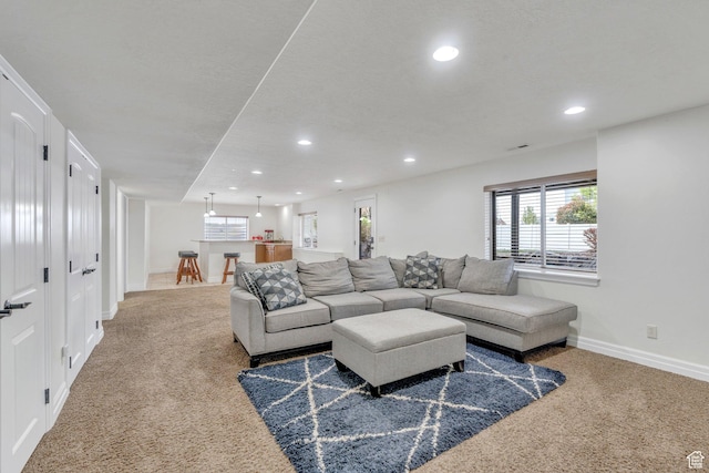 living area with recessed lighting, carpet, and baseboards