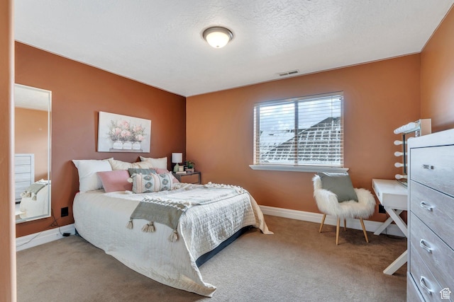 carpeted bedroom with baseboards, visible vents, and a textured ceiling