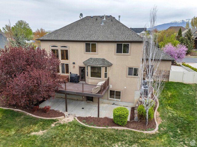 985 W Sunrise Ln, American Fork, UT 84003 - back of house featuring a deck, roof with shingles, a yard, and stucco siding