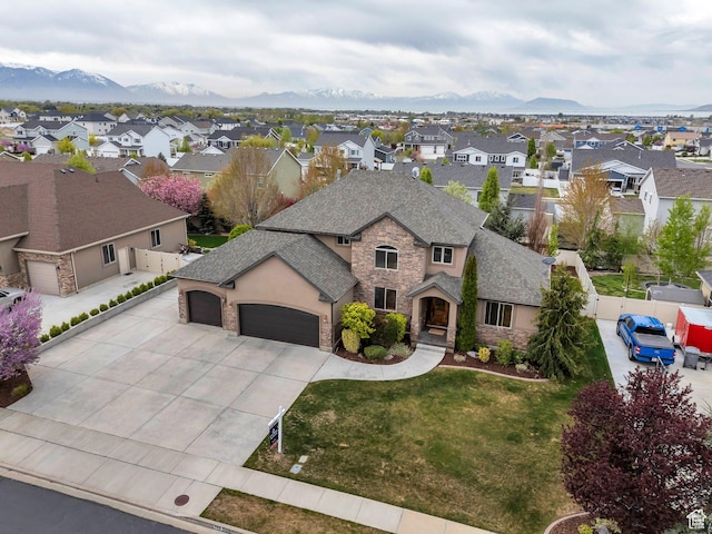 view of front of house featuring a residential view, an attached garage, stone siding, and concrete driveway