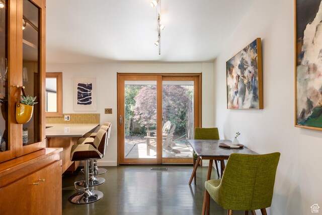 2779 S Connor St S, Millcreek, UT 84109 - dining space with baseboards, wood finished floors, and rail lighting