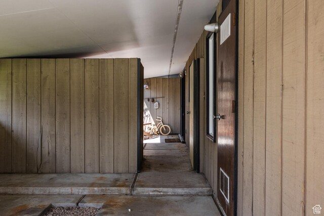 2779 S Connor St S, Millcreek, UT 84109 - hall featuring unfinished concrete floors, visible vents, and wooden walls