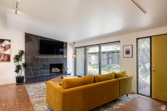 2779 S Connor St S, Millcreek, UT 84109 - living room featuring track lighting, a fireplace, baseboards, lofted ceiling, and visible vents