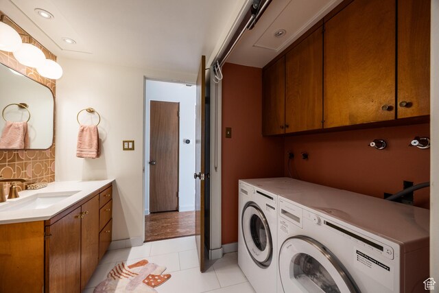 2779 S Connor St S, Millcreek, UT 84109 - washroom featuring washer and clothes dryer, baseboards, light tile patterned flooring, and a sink