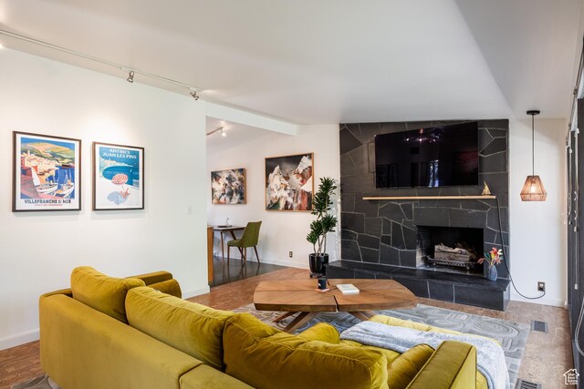 2779 S Connor St S, Millcreek, UT 84109 - living room with visible vents, baseboards, a fireplace, and rail lighting